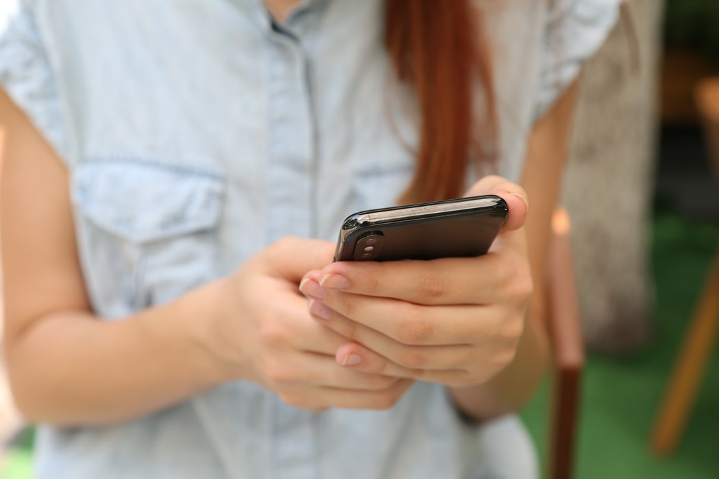 Girl using phone to do local listing management